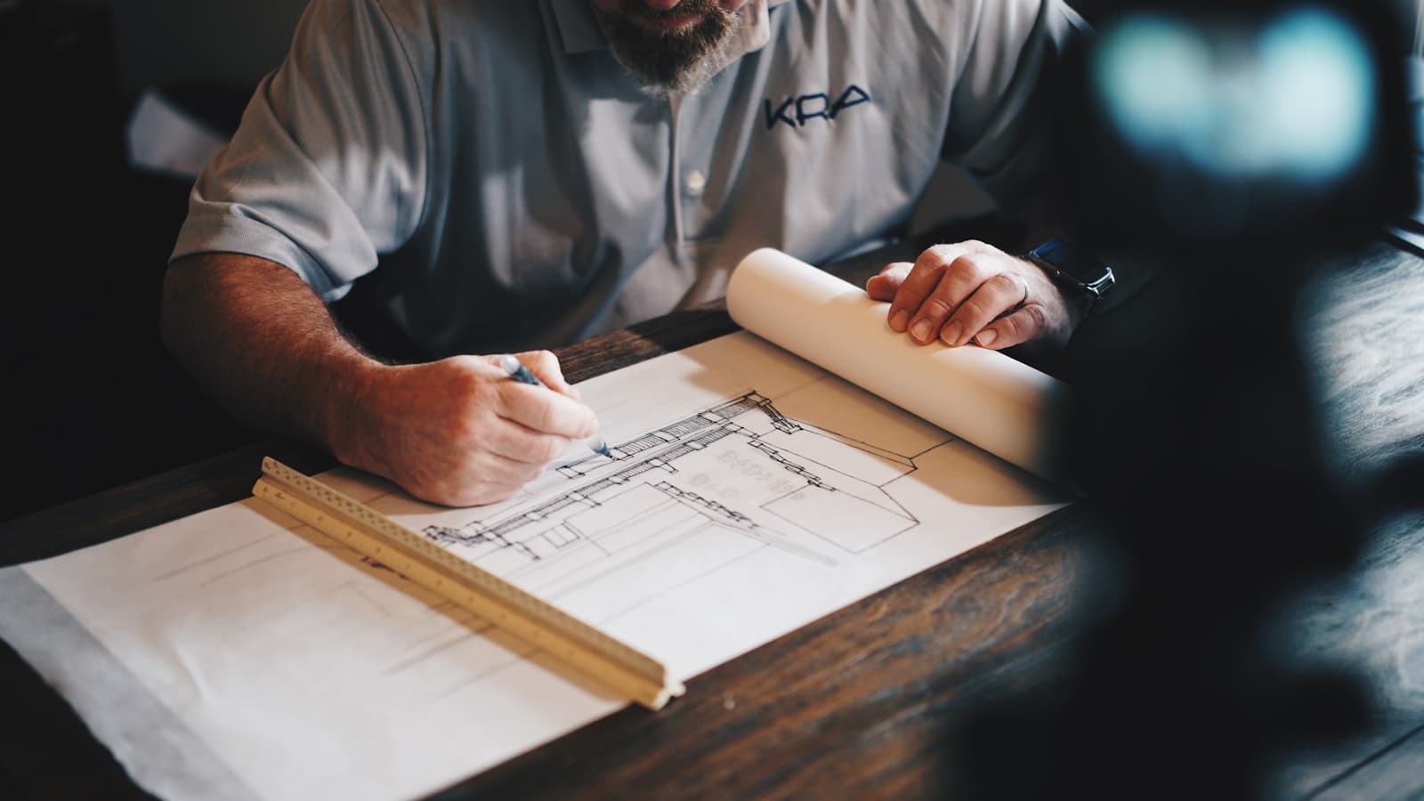 An architect reviewing detailed plans at a desk